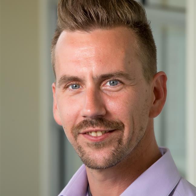 A man wearing a polka dot shirt.
