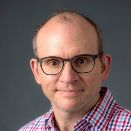A man wearing glasses and a plaid shirt.