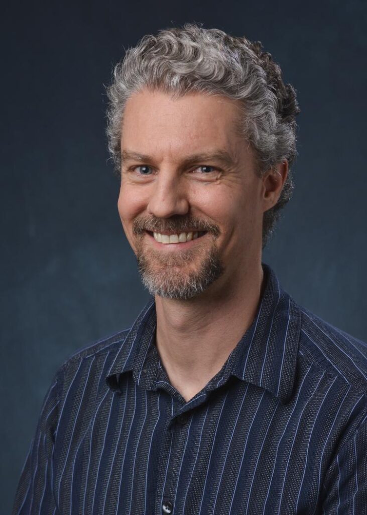 Man with dark stripped shirt.