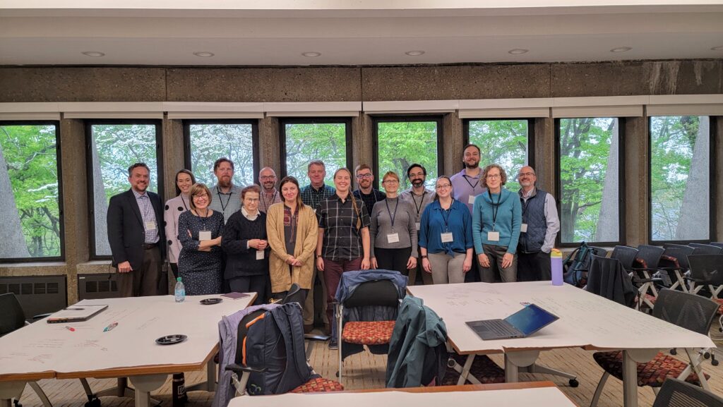 A group of people in front of windows.