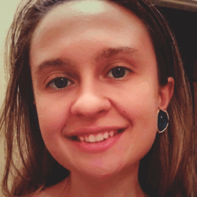 A white woman smiling at the camera.